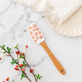 Load image into Gallery viewer, a wooden spatula sitting on top of a marble counter