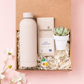 Load image into Gallery viewer, a box containing a bottle of water, a bottle of milk, and a plant

