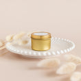 Load image into Gallery viewer, a white plate topped with a small jar of cream
