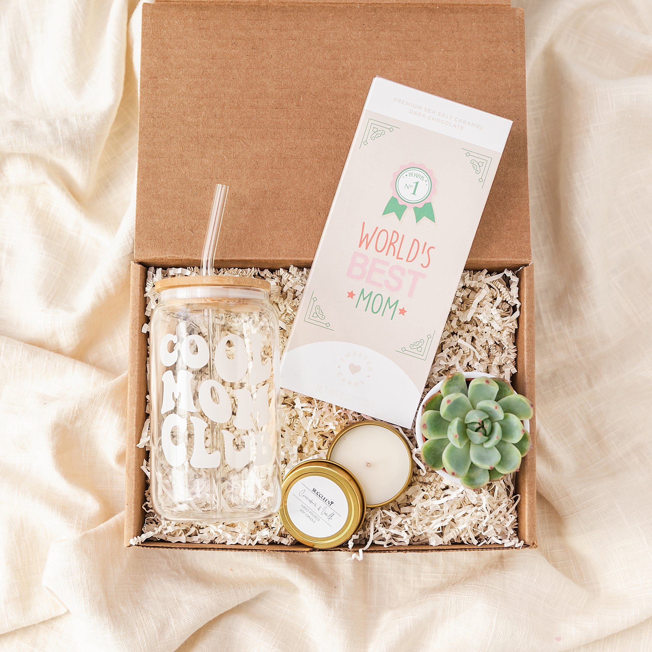 a box with a candle, candle holder, and a card