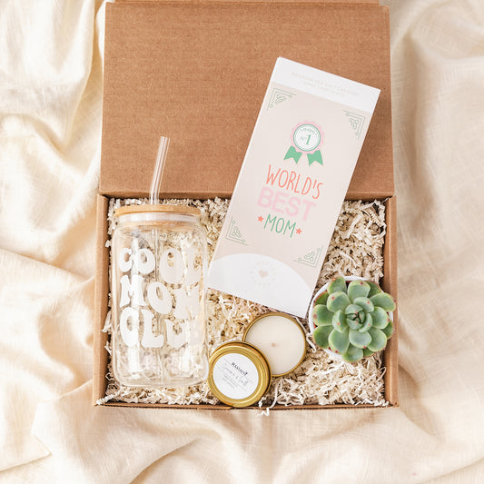 a box with a candle, candle holder, and a card