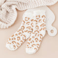 Load image into Gallery viewer, a pair of white and gold leopard print mitts next to a white knitted
