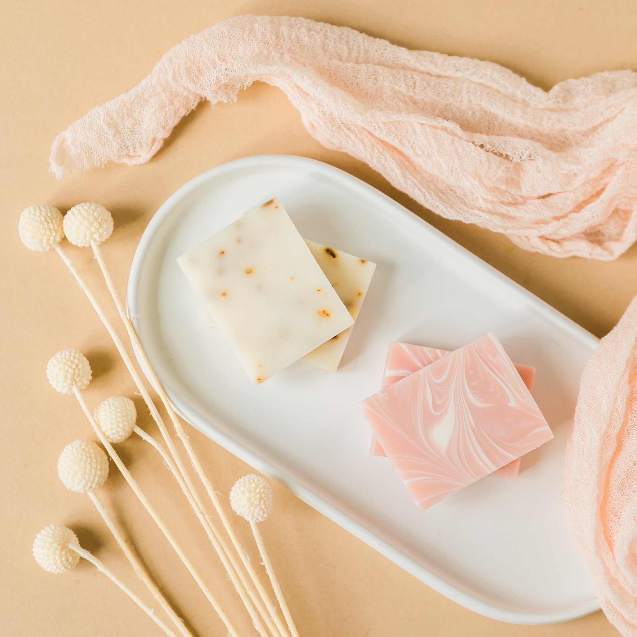 a white tray topped with three different types of soap