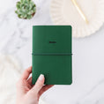 Load image into Gallery viewer, a person holding a green notebook with the word notes written on it
