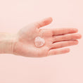 Load image into Gallery viewer, a person's hand holding a piece of clear glass
