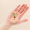 Load image into Gallery viewer, a person's hand holding a ring with a cactus on it
