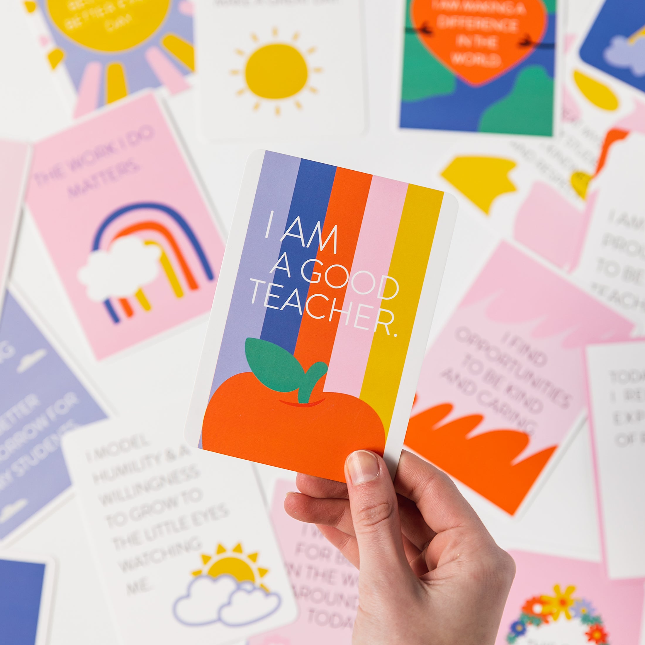a person holding up a card that says i am a good teacher
